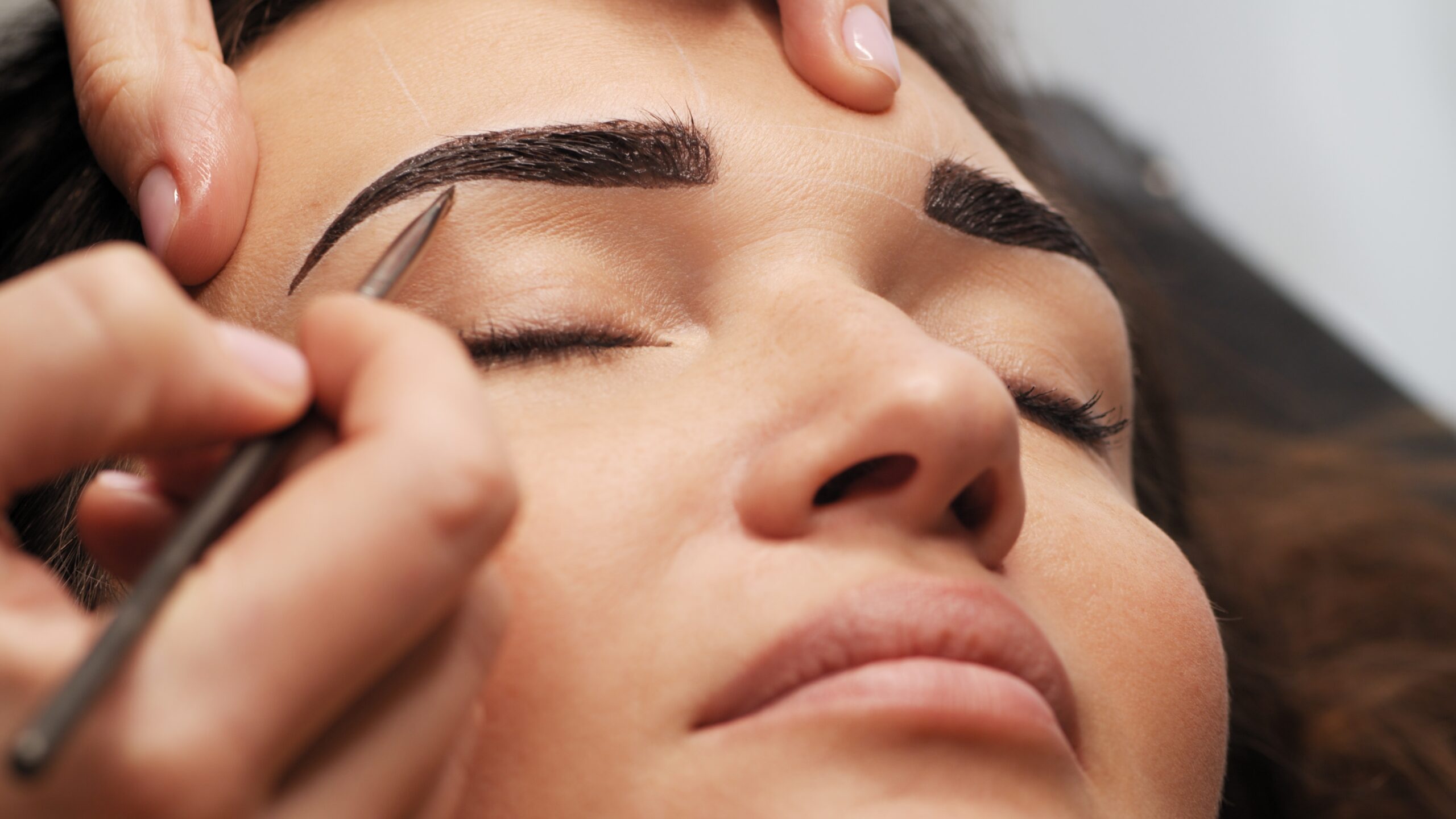 Woman receiving professional eyebrow threading services in Richmond at Athena Mortlake salon