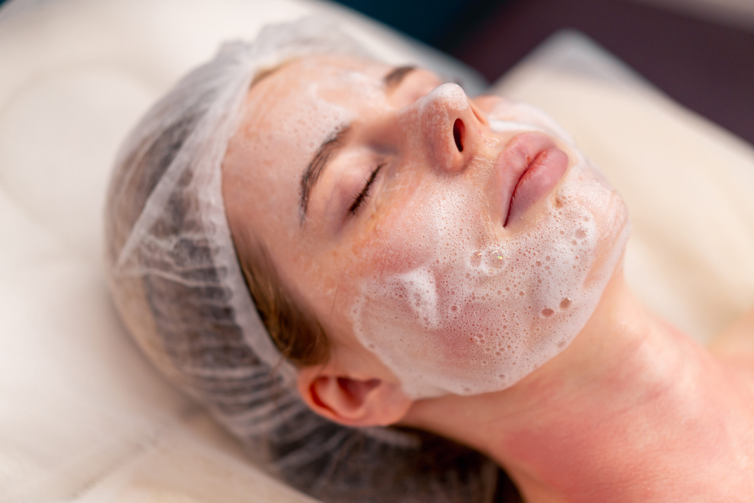 A client enjoying a relaxing, bespoke luxury facial treatment at the Athena Mortlake beauty salon in Richmond.