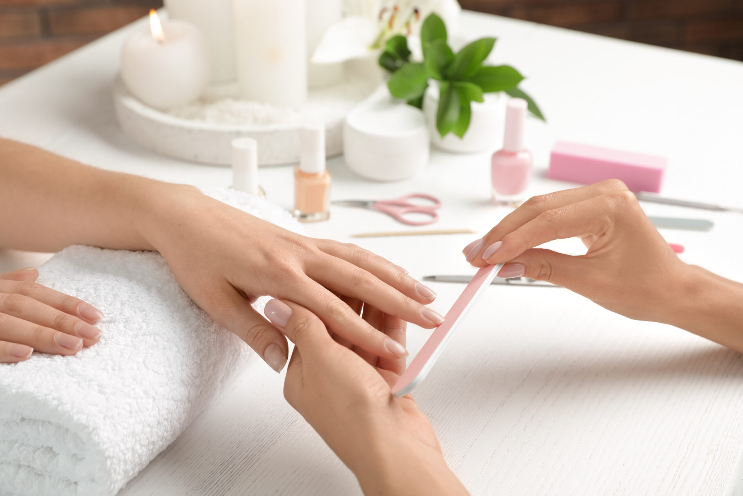 A client receiving luxury nail services in Richmond, featuring a professional manicure and pedicure at Athena Mortlake.